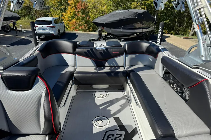 Slide: The Image of 2016 MasterCraft X23 boat interior with sleek seating and modern design. - 11