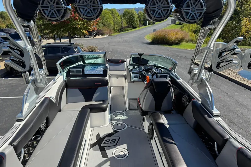 Slide: The Image of 2016 MasterCraft X23 boat interior with sleek seating and advanced audio system. - 13