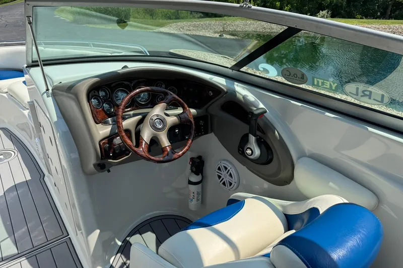 Slide: The Image of 2005 Crownline 270 BR boat cockpit with steering wheel and control panel. - 11