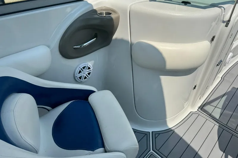Slide: The Image of 2005 Crownline 270 BR boat interior with blue and white seating and speaker. - 12