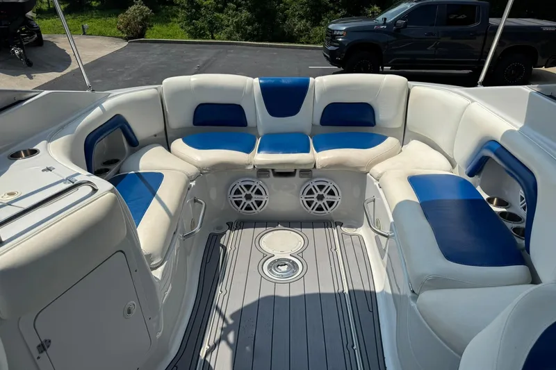 Slide: The Image of 2005 Crownline 270 BR boat interior with blue and white seating, gray flooring. - 14