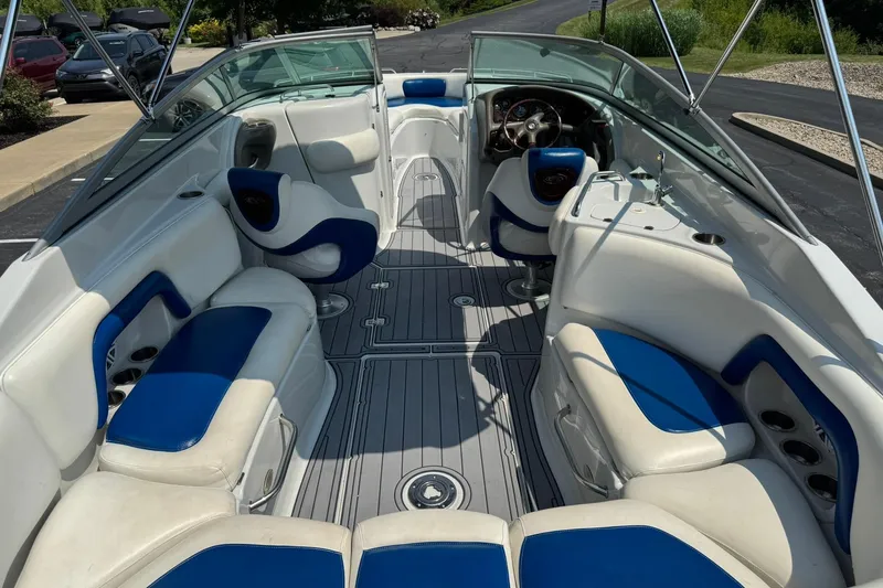 Slide: The Image of 2005 Crownline 270 BR boat interior with blue and white seating, sleek design. - 16
