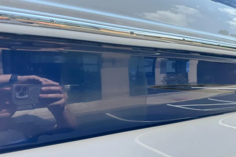 Slide: The Image of Reflection on the side of a 2005 Crownline 270 BR boat. - 17