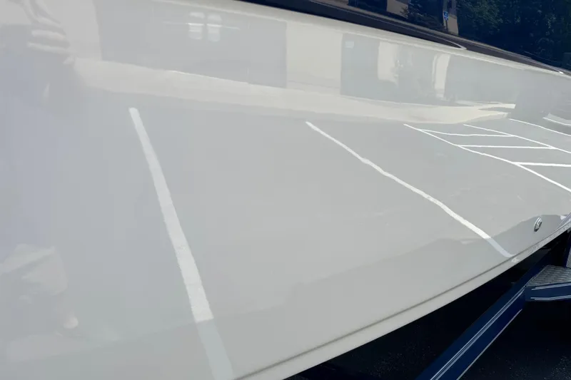 Slide: The Image of 2005 Crownline 270 BR boat hull reflecting parking lot lines. - 18
