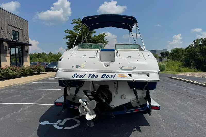 Slide: The Image of 2005 Crownline 270 BR boat named "Seal The Deal" parked outdoors on a sunny day. - 4