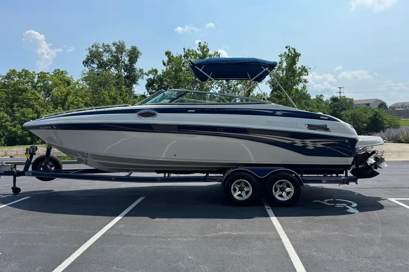 Slide: The Image of 2005 Crownline 270 BR boat on trailer in parking lot, sunny day. - 7