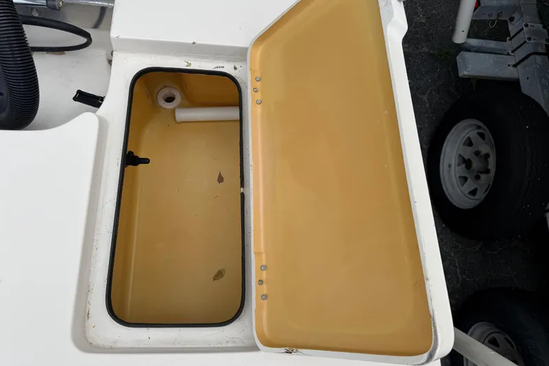 Slide: The Image of Open storage compartment on 2003 Maverick 18 Master Angler boat, showing interior details. - 11