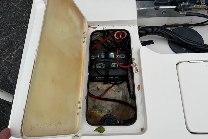 Slide: The Image of Open battery compartment of 2003 Maverick 18 Master Angler boat, showing wiring and components. - 12