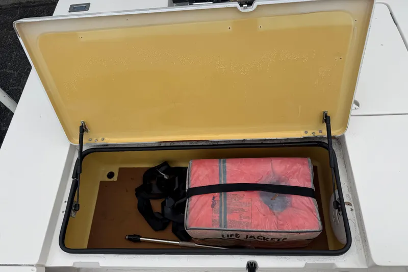 Slide: The Image of Open storage compartment in 2003 Maverick 18 Master Angler boat with life jackets inside. - 14