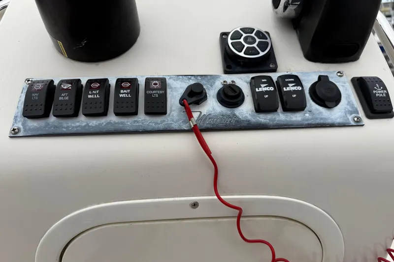 Slide: The Image of Control panel of a 2003 Maverick 18 Master Angler boat with various switches and controls. - 18