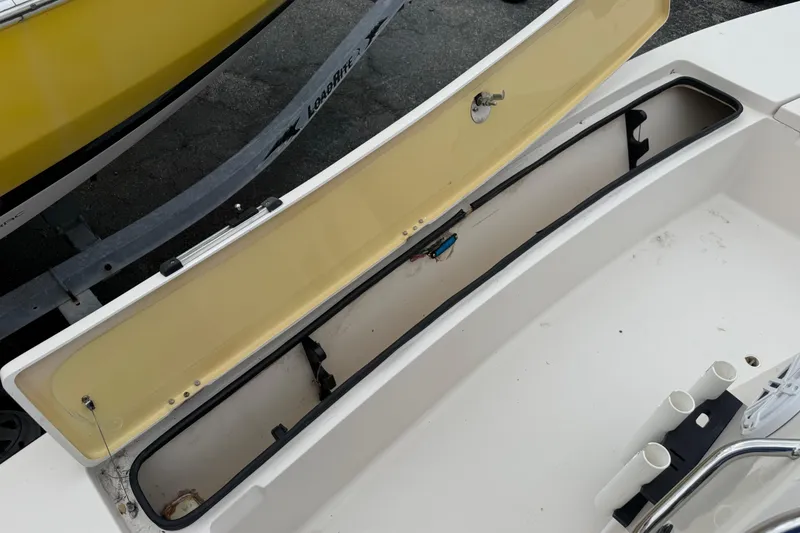 Slide: The Image of Open storage compartment on 2003 Maverick 18 Master Angler boat, with visible rod holders. - 20
