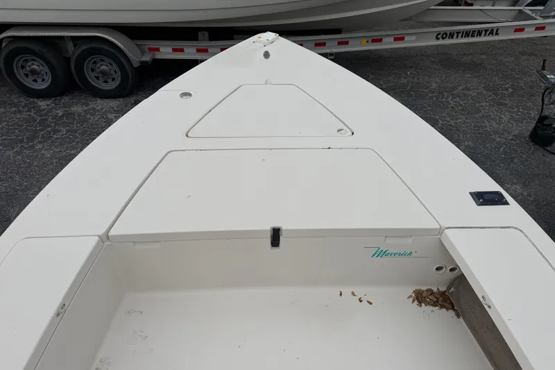 Slide: The Image of 2003 Maverick 18 Master Angler boat deck with storage compartments and trailer in background. - 22