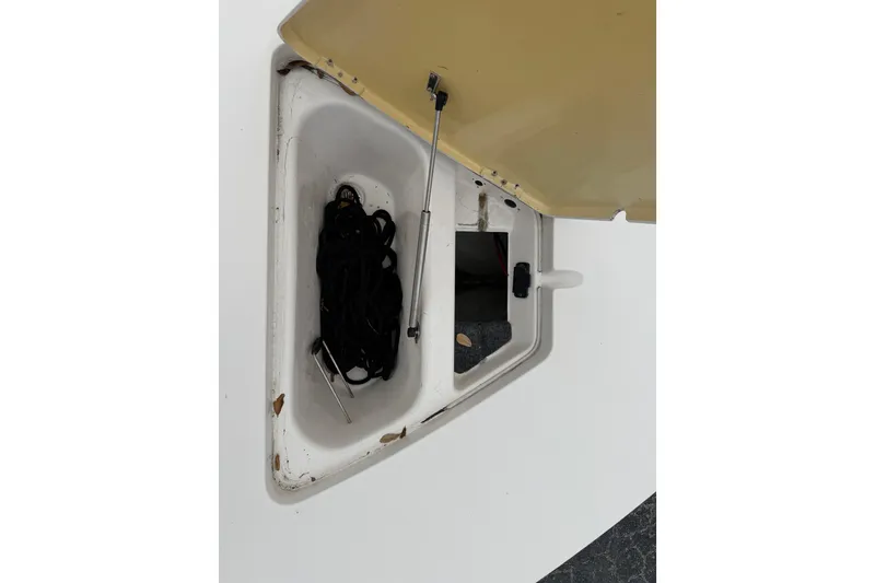 Slide: The Image of Open storage compartment on 2003 Maverick 18 Master Angler boat, showing interior details. - 24
