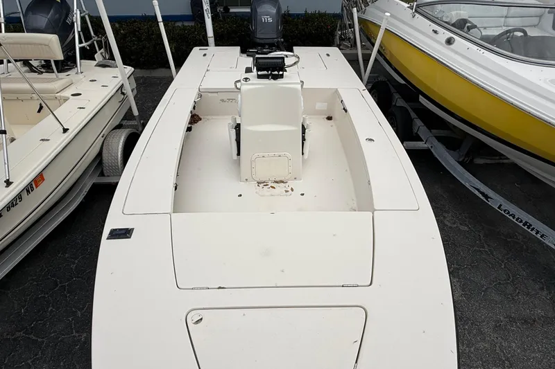 Slide: The Image of 2003 Maverick 18 Master Angler boat, white, parked between two other boats. - 26