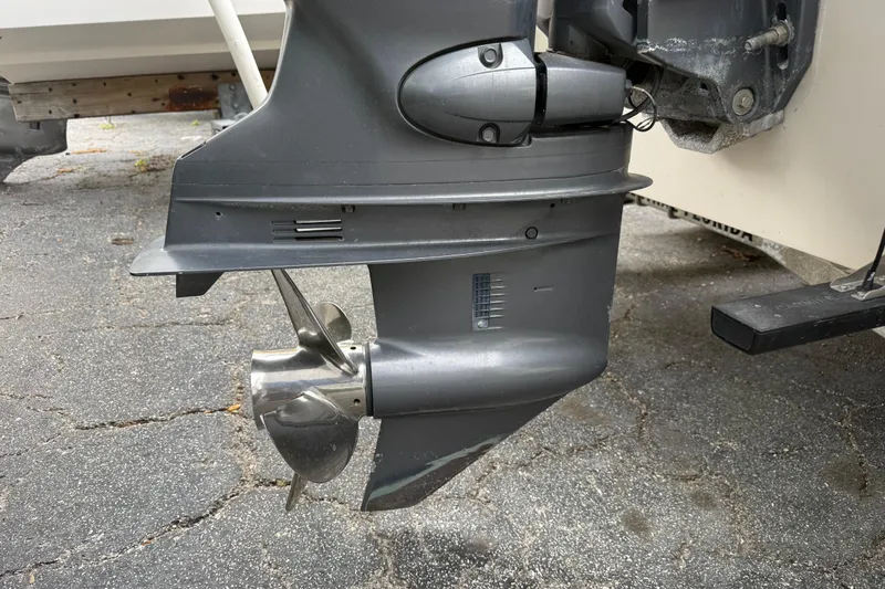 Slide: The Image of Outboard motor of 2003 Maverick 18 Master Angler boat on pavement. - 7