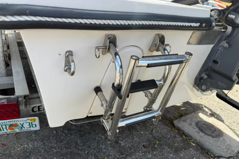 Slide: The Image of 2003 Maverick 18 Master Angler boat with stainless steel ladder and trailer details. - 9