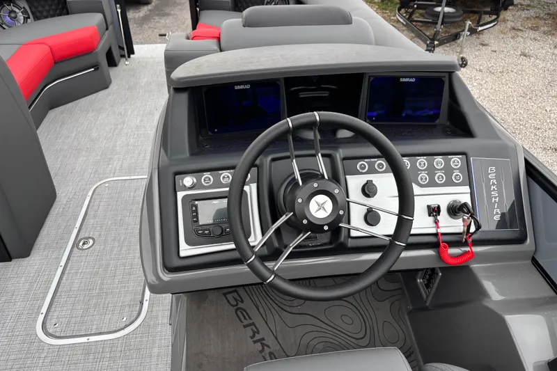 Slide: The Image of 2026 Berkshire 25SB2 STS boat dashboard with steering wheel and control panel. - 15
