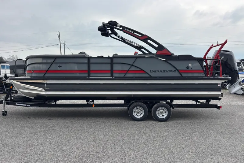 The Image of 2026 Berkshire 25SB2 STS pontoon boat on trailer, sleek design with red accents. - 4