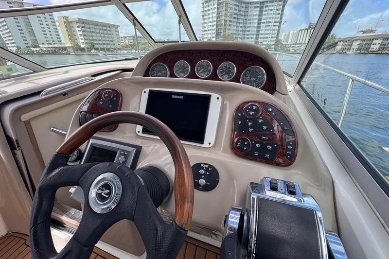 Slide: The Image of Helm of 2005 Sea Ray 300 Sundancer with steering wheel and control panel. - 23