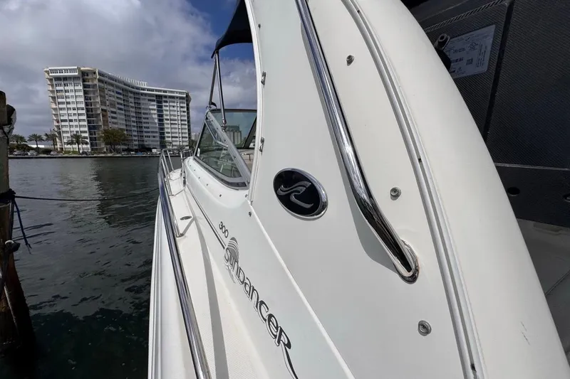 Slide: The Image of 2005 Sea Ray 300 Sundancer yacht docked near waterfront building. - 30