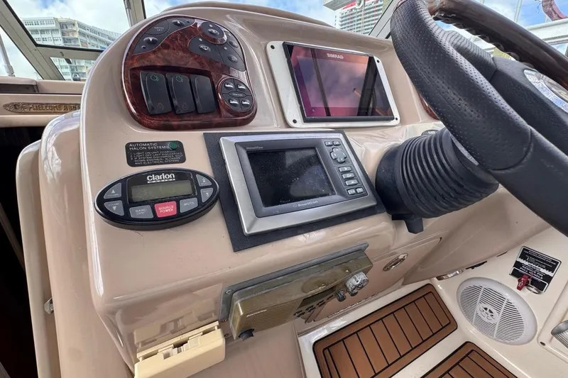 Slide: The Image of Dashboard of a 2005 Sea Ray 300 Sundancer boat with navigation controls. - 35
