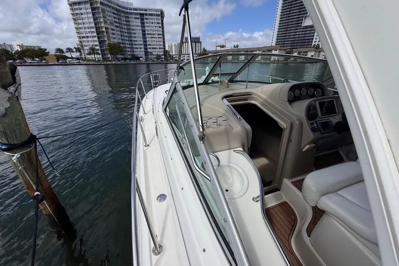 Slide: The Image of 2005 Sea Ray 300 Sundancer docked, showcasing cockpit and luxurious interior design. - 37