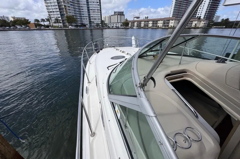 Slide: The Image of 2005 Sea Ray 300 Sundancer docked near waterfront buildings. - 38