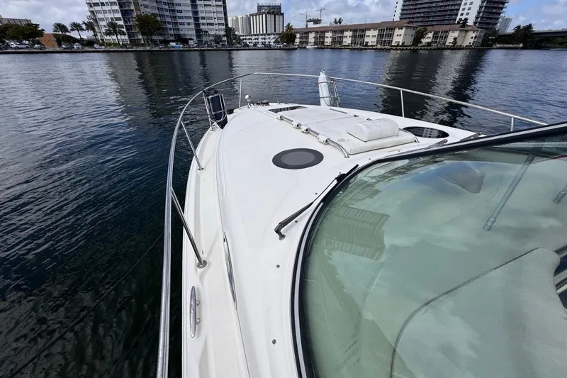 Slide: The Image of 2005 Sea Ray 300 Sundancer boat docked near urban waterfront buildings. - 39