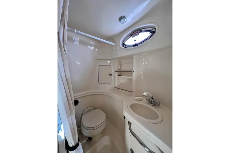 Slide: The Image of 2005 Sea Ray 300 Sundancer docked at marina with cityscape background. - 4