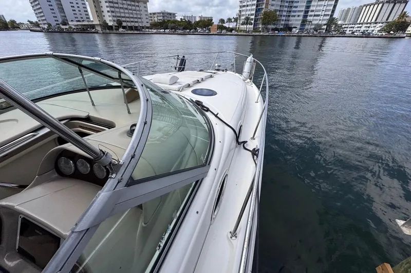 Slide: The Image of 2005 Sea Ray 300 Sundancer yacht docked near waterfront buildings. - 43