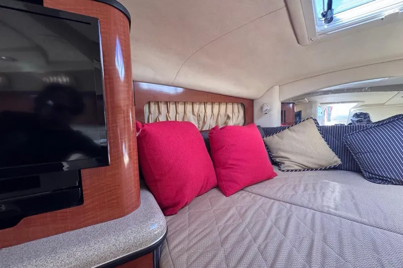 Slide: The Image of Interior of 2005 Sea Ray 300 Sundancer with cozy seating and vibrant cushions. - 54