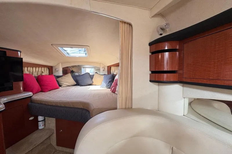 Slide: The Image of Luxurious interior of 2005 Sea Ray 300 Sundancer with cozy bed and elegant wood cabinetry. - 57
