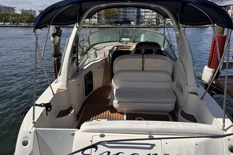 Slide: The Image of 2005 Sea Ray 300 Sundancer boat docked, featuring spacious seating and elegant design. - 6