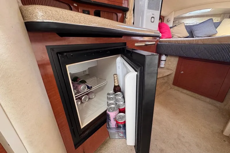 Slide: The Image of Mini fridge in 2005 Sea Ray 300 Sundancer cabin, stocked with beverages. - 70