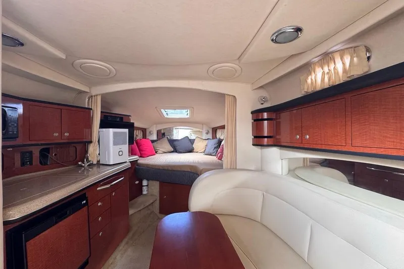 Slide: The Image of Interior of 2005 Sea Ray 300 Sundancer yacht with cozy seating and kitchenette. - 78