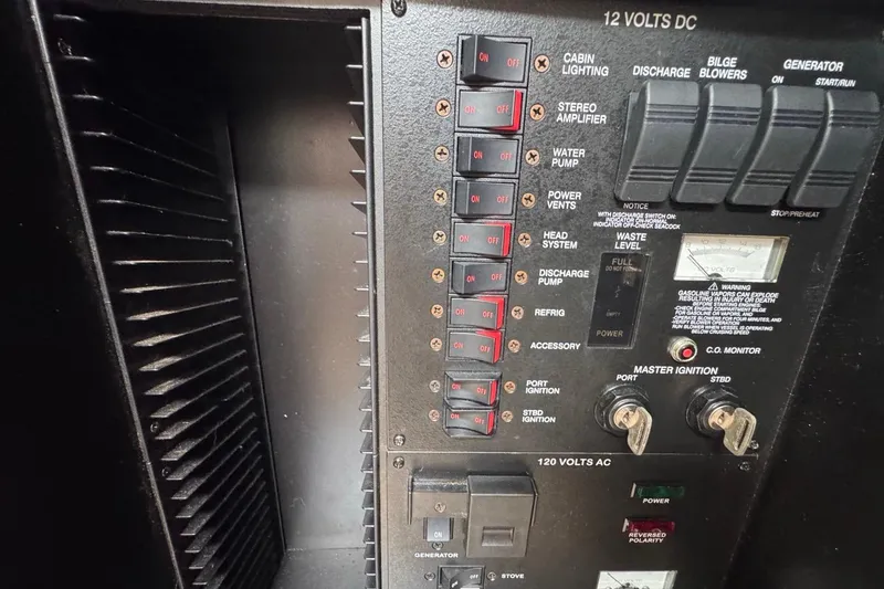 Slide: The Image of Control panel of a 2005 Sea Ray 300 Sundancer boat, showing switches and gauges. - 80
