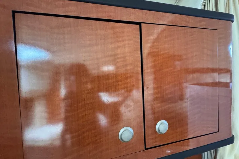 Slide: The Image of Polished wooden cabinet doors inside a 2005 Sea Ray 300 Sundancer boat. - 81