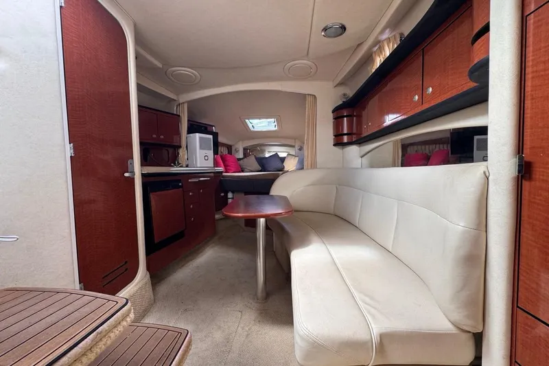 Slide: The Image of Luxurious interior of 2005 Sea Ray 300 Sundancer yacht with elegant seating and kitchenette. - 88