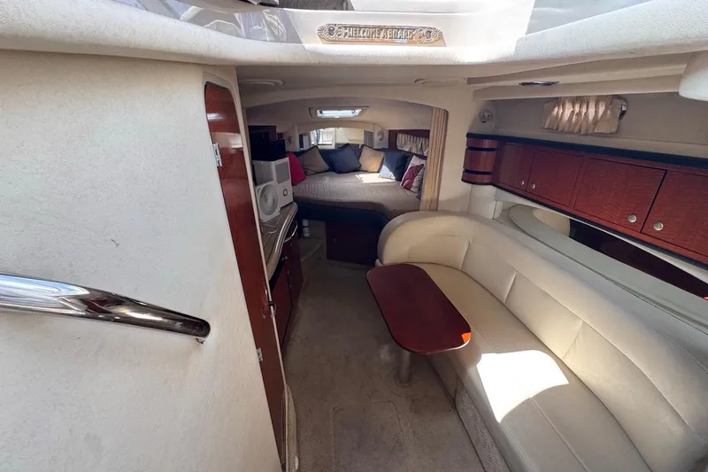 Slide: The Image of Interior of 2005 Sea Ray 300 Sundancer yacht with cozy seating and bed area. - 89