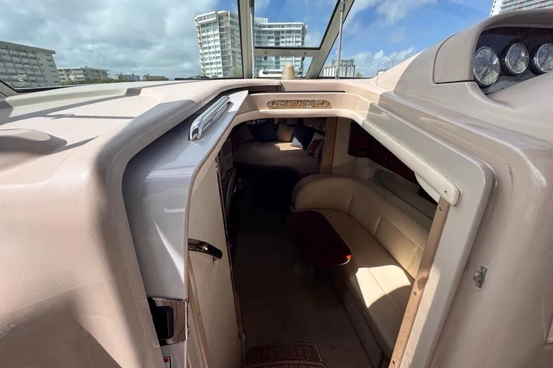 Slide: The Image of 2005 Sea Ray 300 Sundancer cabin interior with seating and cityscape view. - 90