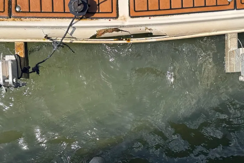 Slide: The Image of Damaged 2005 Sea Ray 300 Sundancer boat hull above water. - 92