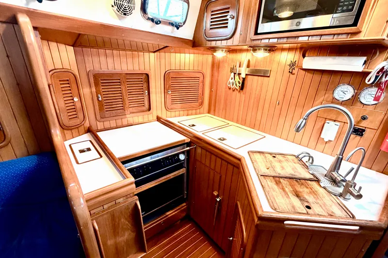 Slide: The Image of Cozy wooden kitchen in 2001 Tayana Vancouver 42 yacht with modern amenities. - 10