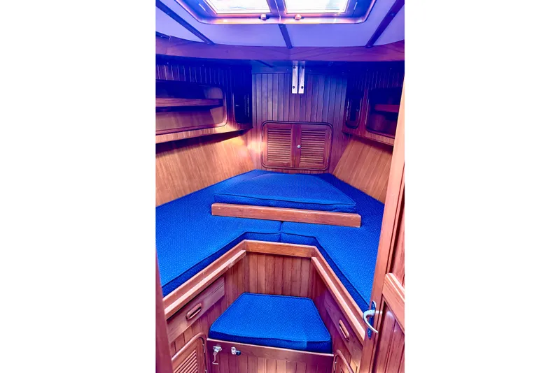 Slide: The Image of Cabin interior of 2001 Tayana Vancouver 42 sailboat with blue cushions and wooden finish. - 12