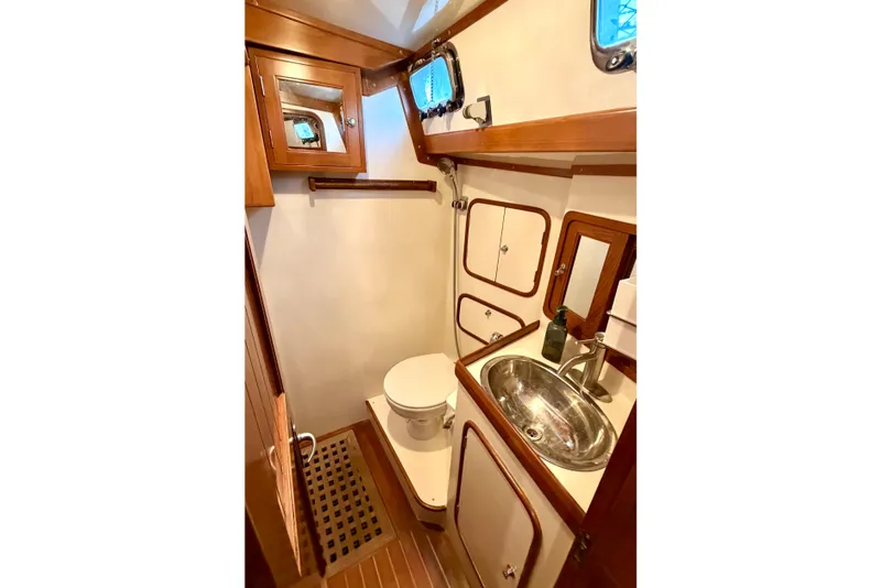 Slide: The Image of Bathroom interior of 2001 Tayana Vancouver 42 yacht, featuring wood accents and stainless steel sink. - 13