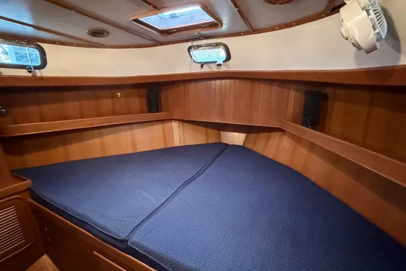 Slide: The Image of Cozy cabin interior of 2001 Tayana Vancouver 42 sailboat with wooden finish and blue bedding. - 16