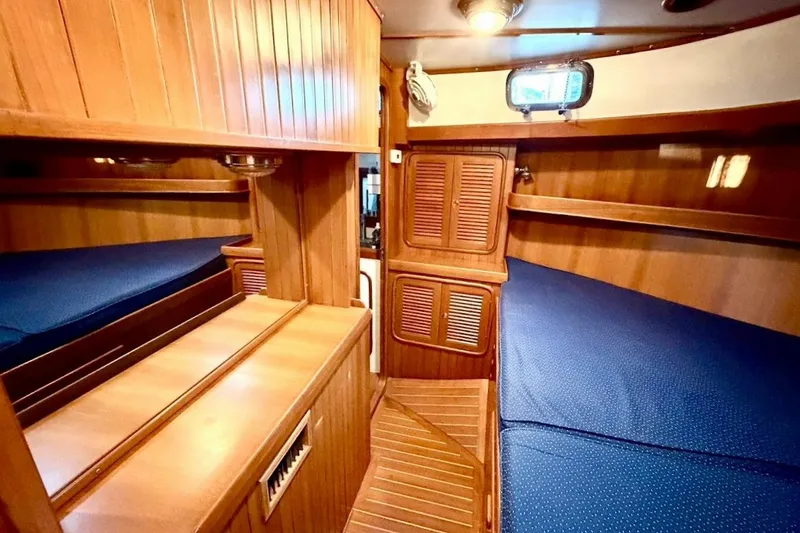 Slide: The Image of Cozy wooden interior of 2001 Tayana Vancouver 42 sailboat cabin with blue bedding. - 17