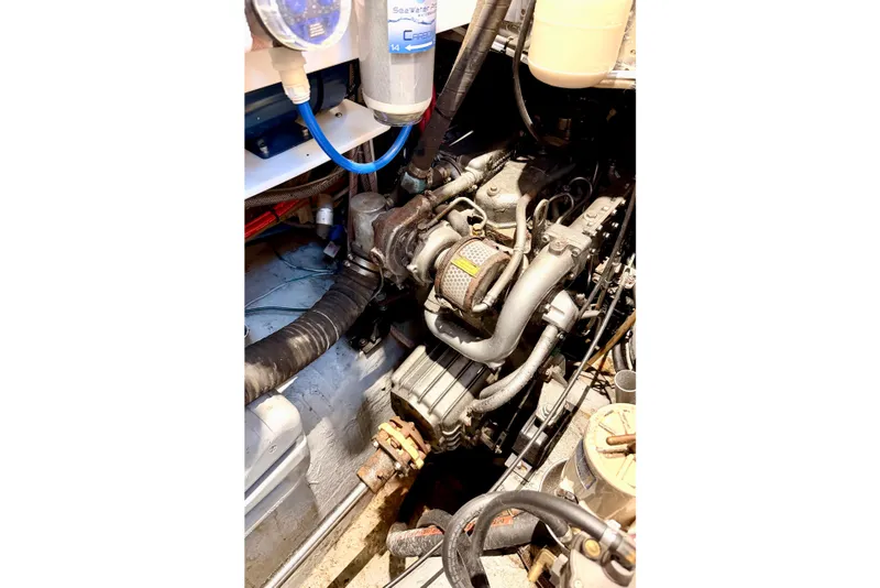 Slide: The Image of Engine compartment of a 2001 Tayana Vancouver 42 sailboat, showcasing mechanical components. - 24