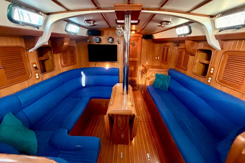 Slide: The Image of Luxurious interior of 2001 Tayana Vancouver 42 yacht with blue seating and wooden finishes. - 4