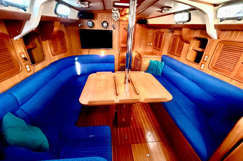 Slide: The Image of Interior of 2001 Tayana Vancouver 42 yacht with blue seating and wooden finishes. - 5