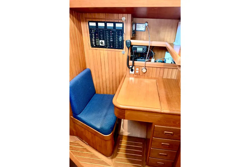 Slide: The Image of 2001 Tayana Vancouver 42 yacht interior with navigation station and blue cushioned seat. - 9